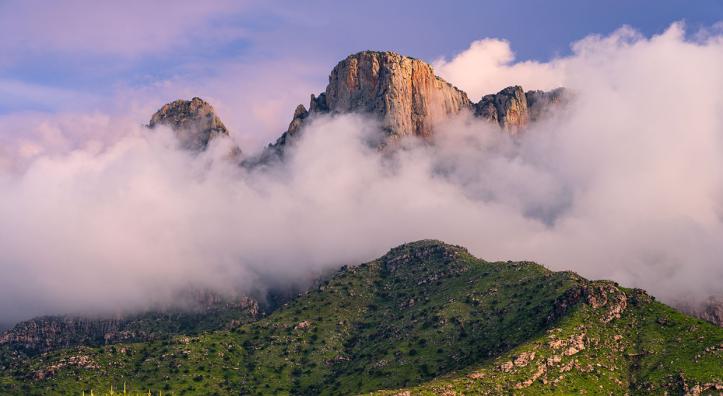  Low-hanging storm clouds cloak the cliffs of the Pusch Ridge Wilderness in the Santa Catalina Mountains, near Tucson.  By Jack Dykinga
