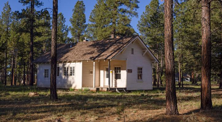 The research station is a small white building nestled between ponderosa pines. By John Burcham