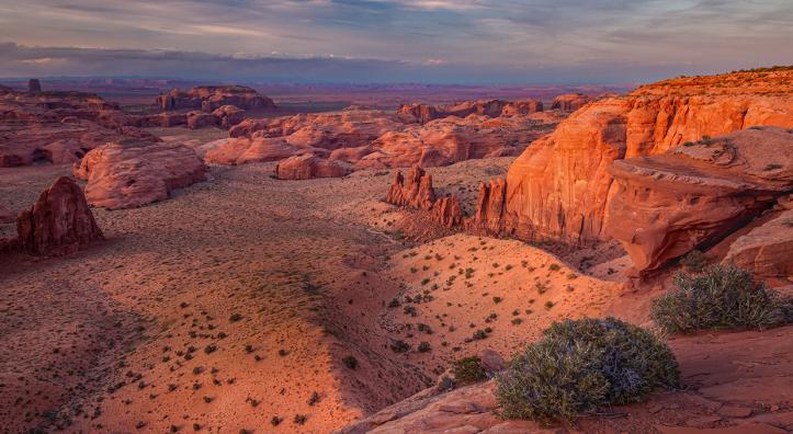 Shadows cloak the sandstone buttes of Monument Valley in a sunset view from Hunts Mesa. By Larry Lindahl