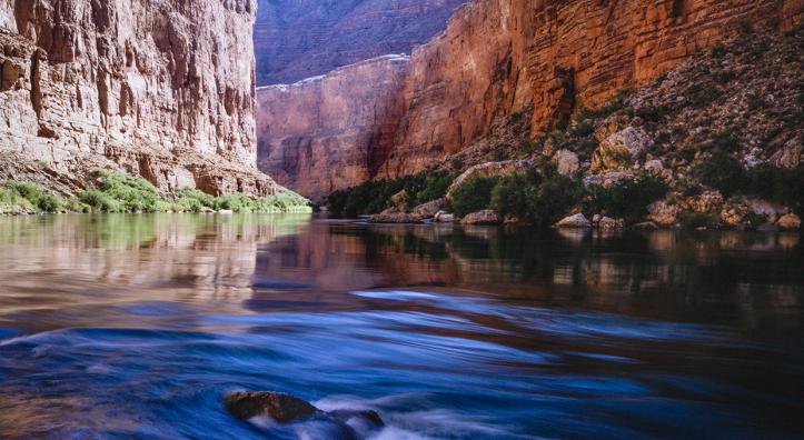 Summer sunlight pours into Marble Canyon, the upstream portion of Grand Canyon National Park, as the Colorado River flows over rocks. This spot is 41 miles downstream from Lees Ferry, considered the start of the Canyon’s 277-mile course. By Gary Ladd