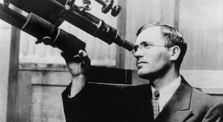 Clyde Tombaugh peers through a 6-inch telescope at the  University of Kansas, where he earned bachelor’s and master’s degrees. This photo was made in 1936, six years after Tombaugh’s discovery  of Pluto at Flagstaff’s Lowell Observatory. | New Mexico State University