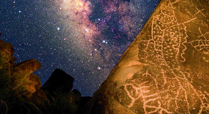 In this composite image, Hohokam rock art is illuminated against a Milky Way backdrop in Southern Arizona’s Picacho Mountains. The long swath of dots may symbolize the universe, along with other sky objects and serpents, which are thought to represent prayers being carried to the gods. | Frank Zullo