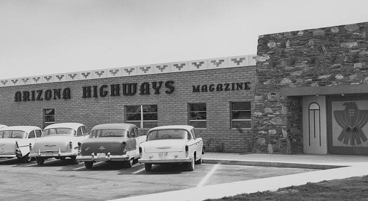 Black and white photo of Phoenix building that is home to Arizona Highways magazine, with mid-century automobiles parked in the front lot. | Arizona Highways Archives