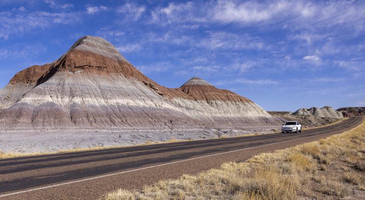 Author Noah Austin navigates an electric vehicle through the Tepees, a section of Petrified Forest National Park. While Arizona’s other two national parks, Grand Canyon and Saguaro, have fast charging stations nearby, the Petrified Forest area poses challenges for EV road-trippers. | John Burcham