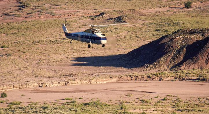 A Sikorsky helicopter lifts the remains of Chindesaurus bryansmalli, a dinosaur popularly known as “Gertie,” from the layered landscape of Petrified Forest National Park on June 6, 1985. The fossilized dinosaur was discovered near what now is called Hózhó Point. | Jeff Kida