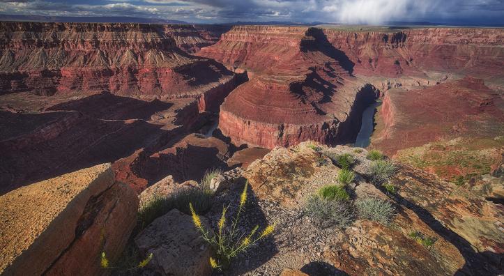 A dramatic view of Horseshoe Bend from the rim or Marble Canyon under cloudy skies. By Shane McDermott