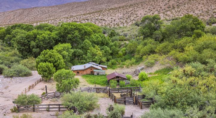 Immediately surrounded by green vegetation, Tassi Ranch sits on a rugged and remote stretch of northwest Arizona. By John Burhcam