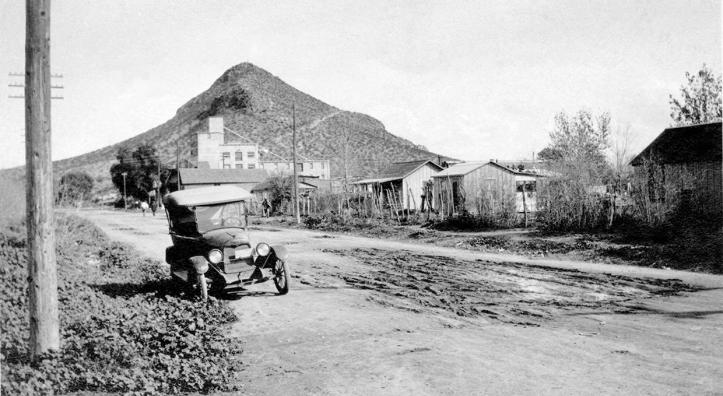 Spartan residences line Tempe’s unpaved First Street  in the 1920s. This view is looking east toward the Hayden Flour Mill and Tempe Butte, better known today as “A” Mountain. | Tempe History Museum
