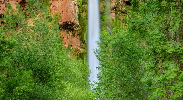 Plunging nearly 200 feet into a turquoise pool, Mooney Falls is per-haps the most dramatic cascade in the village of Supai, at the far western edge of the Grand Canyon. | Suzanne Mathia