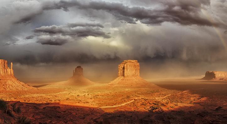 A stitched panorama of three photos made during an autumn storm at Monument Valley is by Enio Lanaro.