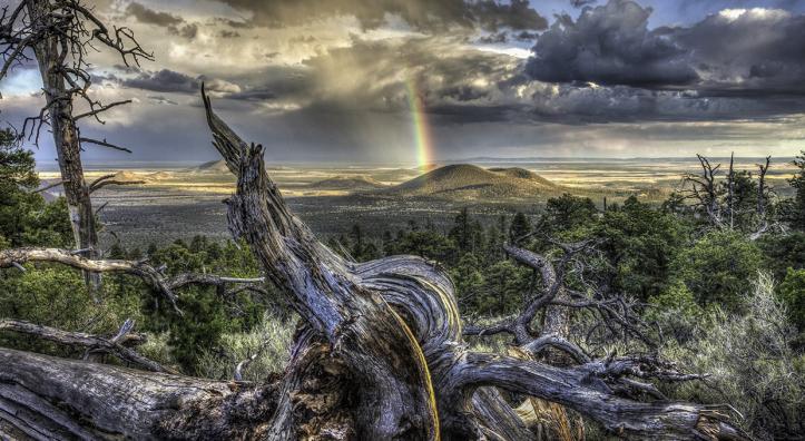The volcanic landscape of Maroon Crater and the approaching evening light are punctuated by a bright rainbow. By Bernhard Michaelis