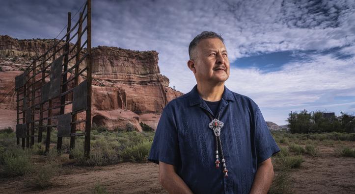 Master Diné silversmith Alvin Yellowhorse stands on the property of the former Ortega’s Indian Market in Lupton, with the Painted Cliffs behind him. | Joel Grimes