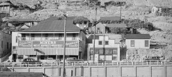 A sign on a building advertises Apache Beer.