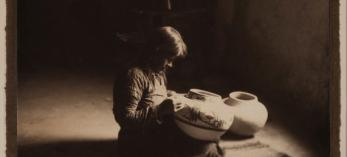A sepia toned image shows a portrait of a young potter