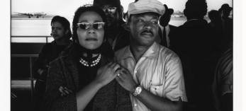 A black and white image depicts Coretta Scott King and Martin Luther King Jr.