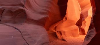 A color photographs show the intricate sandstone geology of Antelope Canyon, a slot canyon in Northeastern Arizona. 