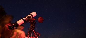A visitor to the North Rim of Grand Canyon National Park looks through a telescope during the Grand Canyon Star Party. Photograph by John Burcham.