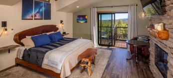 Room with fireplace and view of pine forest. Photograph by John Burcham.