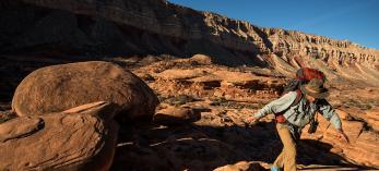 Writer Tyler Williams navigates around sandstone formations on the Esplanade below Fishtail Mesa. By Bill Hatcher