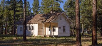 The research station is a small white building nestled between ponderosa pines. By John Burcham