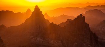 Sunrise in the Kofa Mountains displays layered hues of yellow, orange and brown. By Joel Hazelton