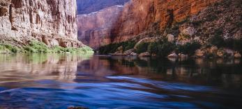 Summer sunlight pours into Marble Canyon, the upstream portion of Grand Canyon National Park, as the Colorado River flows over rocks. This spot is 41 miles downstream from Lees Ferry, considered the start of the Canyon’s 277-mile course. By Gary Ladd