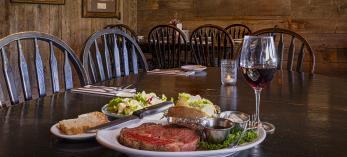 Prime rib, baked potato, salad and all the fixins' plus a glass of red wine at Molly Butler Lodge and Restaurant. By John Burcham