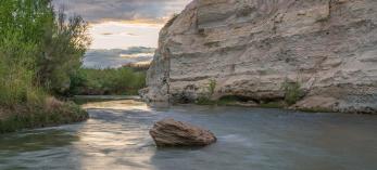 The Verde River flows past the imposing namesakes of the White Cliffs Trail. By Laurence Parent