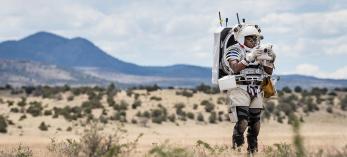 NASA astronaut Andre Douglas simulates a moonwalk in the San Francisco Volcanic Field, north of Flagstaff, in May of this year. Currently, Douglas is on the backup crew for Artemis II, a lunar flyby mission planned for September 2025. JOSH VALCARCEL/COURTESY OF NASA