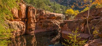 Fall color surrounds Wet Beaver Creek’s “The Crack,” a highlight of the Bell Trail. By Laurence Parent