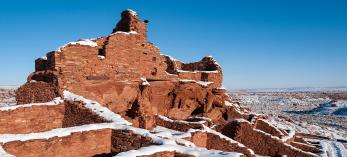 A raven and a fresh coat of snow adorn Wupatki Pueblo, the centerpiece of Wupatki National Monument. The pueblo is accessible via a short walk from the monument’s visitors center. By Elias Butler