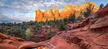 The Seven Sacred Pools, a landmark  on the Soldier Pass Trail, mirror the spires of Coffeepot Rock. By Larry Lindahl
