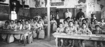 Students, teachers and other staff at a federal Indian boarding school in the Kingman area pose for a photo around 1900. | University of Southern California DIGITAL LIBRARY, California Historical Society Collection