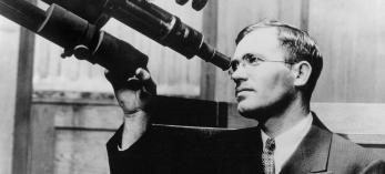 Clyde Tombaugh peers through a 6-inch telescope at the  University of Kansas, where he earned bachelor’s and master’s degrees. This photo was made in 1936, six years after Tombaugh’s discovery  of Pluto at Flagstaff’s Lowell Observatory. | New Mexico State University