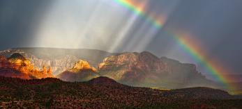 Falling rain and a rainbow bring a dreamlike vibe to a view of Red Rock Country. Such otherworldly views may be part of the reason the Sedona area has become a destination for those seeking paranormal experiences. | Guy Schmickle