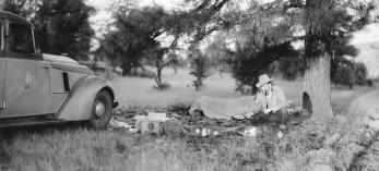 Norman G. Wallace sets up camp near his Arizona Highway Department vehicle in an undated photo. | Arizona Historical Society