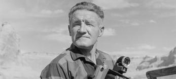 BW photo of Josef Muench posing with 4x5 camera. | NORTHERN ARIZONA UNIVERSITY CLINE LIBRARY