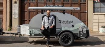 Tim Elinski stands in front of a travel trailer. By Paul Markow