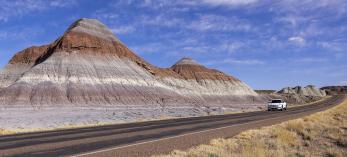 Author Noah Austin navigates an electric vehicle through the Tepees, a section of Petrified Forest National Park. While Arizona’s other two national parks, Grand Canyon and Saguaro, have fast charging stations nearby, the Petrified Forest area poses challenges for EV road-trippers. | John Burcham