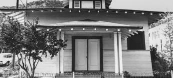 The front of the two-story Bisbee Woman’s Club’s clubhouse, dedicated in 1902, is shown behind a low wire fence. Courtesy NATIONAL PARK SERVICE