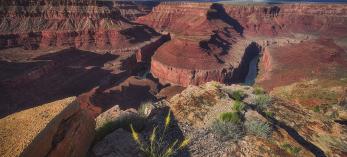 A dramatic view of Horseshoe Bend from the rim or Marble Canyon under cloudy skies. By Shane McDermott