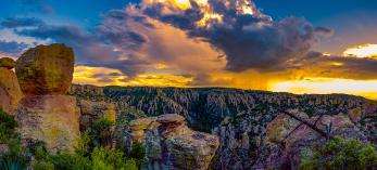 A colorful monsoon storm dumps rain over the hoodoos in the Chiracahua Mountains, near Willcox, Arizona.