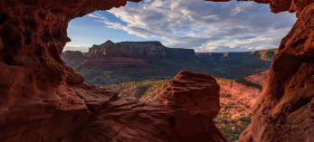 A sandstone cave near Schnebly Hill Road frames a panorama of Red Rock Country. By Chirag Patel