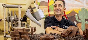 Photograph of Tony Cerreta surrounded by chocolates by Jill Richards