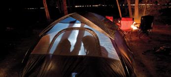 Four Canyon novices huddle inside their tent during a cold night at Mather Campground on the Grand Canyon’s South Rim. By Peter Schwepker