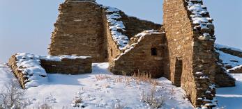 Draped in a layer of snow, Pueblo del Arroyo’s massive stone walls stand deserted in Chaco Culture National Historical Park, New Mexico. Early Southwestern dwellers left behind many clues that help historians understand ancient cultures. | George H.H. Huey