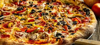 Photograph of loaded pizza is by Steven Meckler.