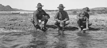 Three members of the Arizona National Guard fill their canteens with Colorado River water during a 1934 showdown with California over the construction of Parker Dam. | UCLA CHARLES E. YOUNG RESEARCH LIBRARY