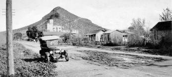 Spartan residences line Tempe’s unpaved First Street  in the 1920s. This view is looking east toward the Hayden Flour Mill and Tempe Butte, better known today as “A” Mountain. | Tempe History Museum