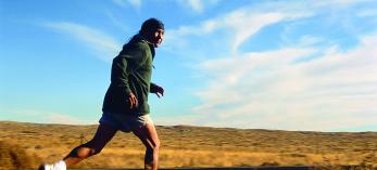 pounding the road  Dale Jackson runs along the road between the Hopi village of Moenkopi and Dilkon, on the Navajo Indian Reservation, during a 100-mile training relay. Shadows form in the red rock badlands (right) on the Hopi Indian Reservation. | Gary Johnson
